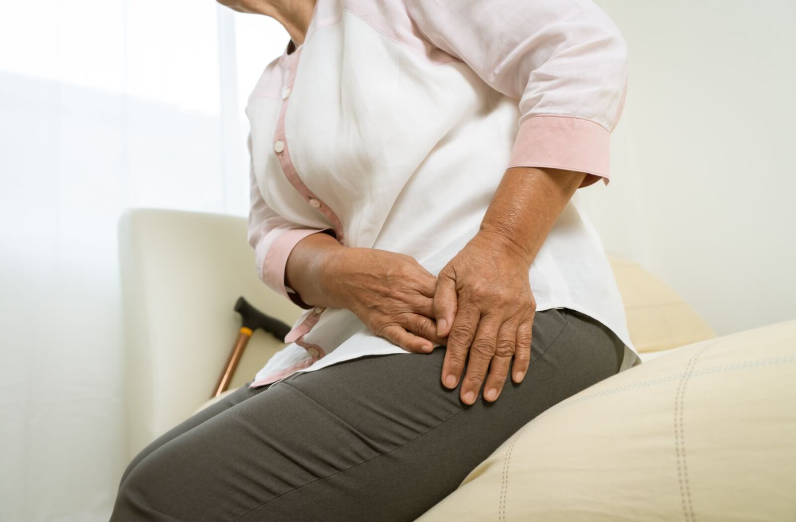 A senior suffering from hip pain from a hip fracture