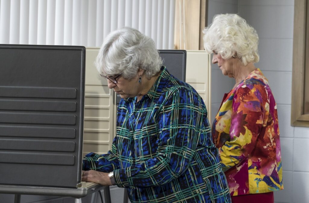 wo seniors cast their votes at a polling station.